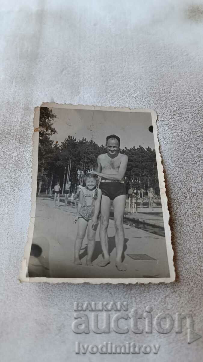 Photo Sofia A man and a little girl by the pool