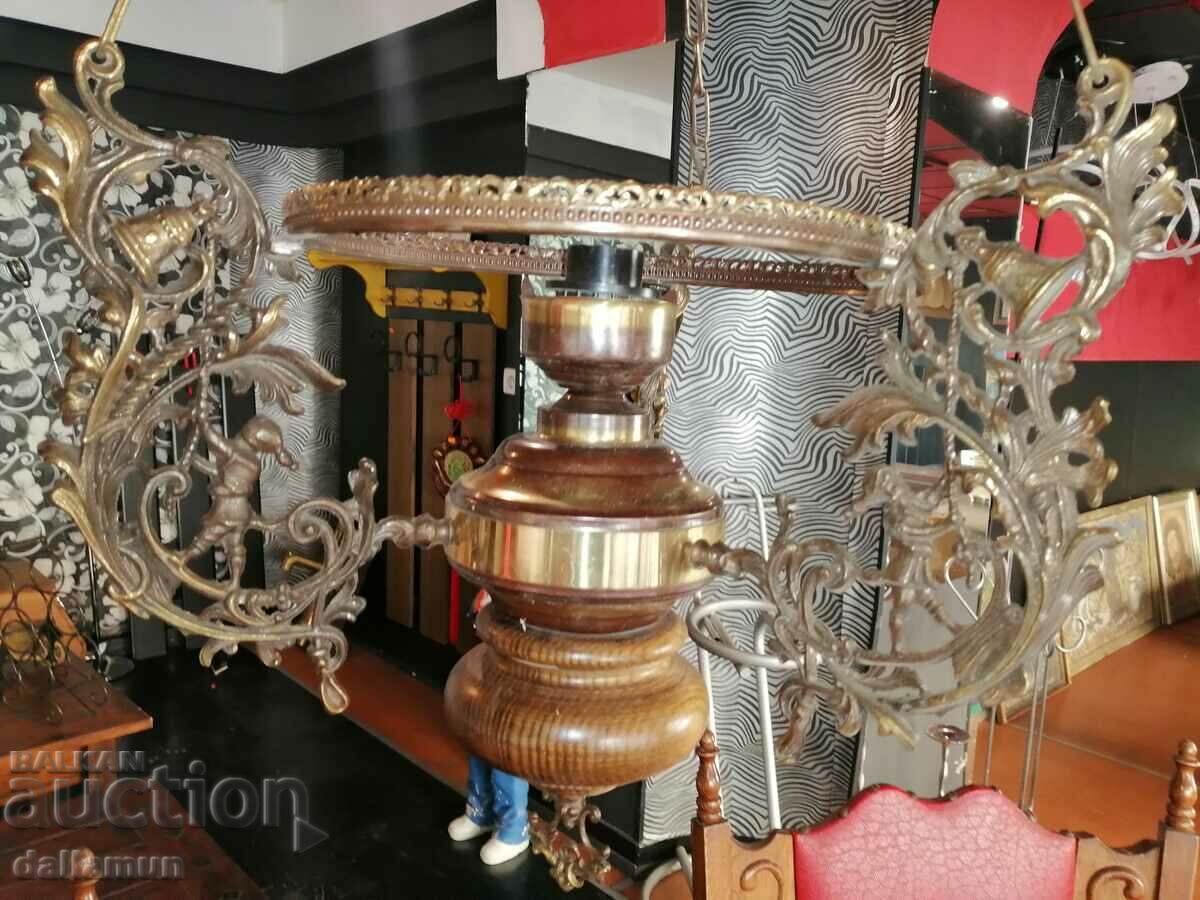 Auction antique chandelier with brass details and wooden base Auction antique chandelier with brass details and wooden base