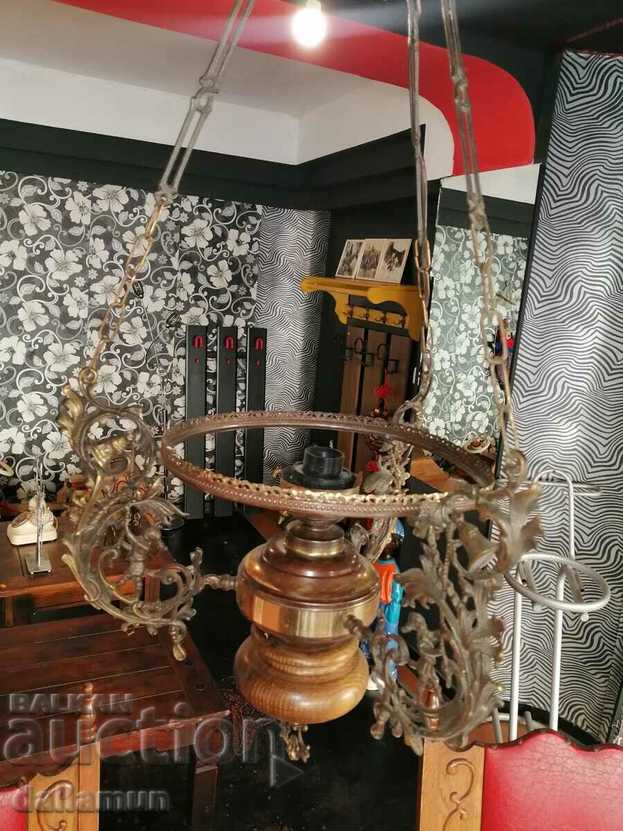 antique chandelier with brass details and wooden base