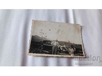 Photo Three men and a woman with a retro car with a ret. No. PL 138