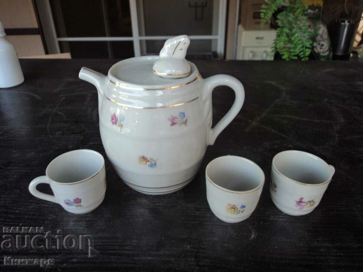 Old porcelain teapot with three cups