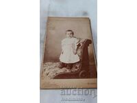 Photo Little girls in a white dress on a chair Cardboard