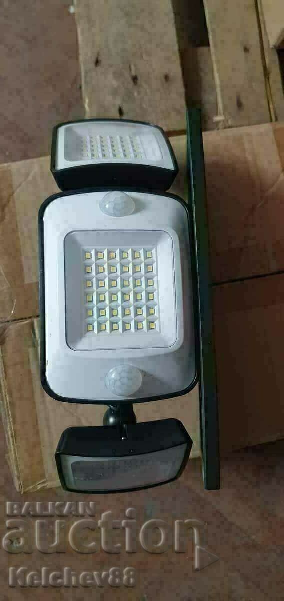 Solar floodlight with photocell