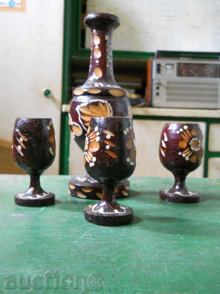 Set of wooden cups and bottle