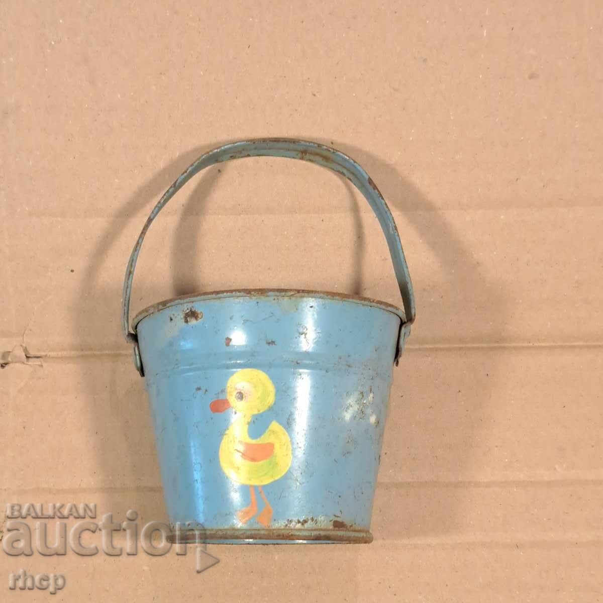 Old tin toy bucket with a duck