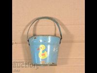 Old tin toy bucket with a duck