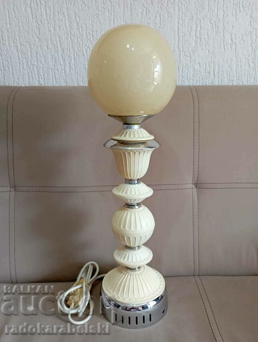 A beautiful lamp with a yellow glass shade