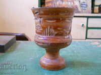 Old wooden mortar with carving