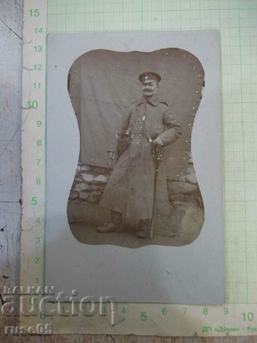 Old photo of a man in uniform with a sword