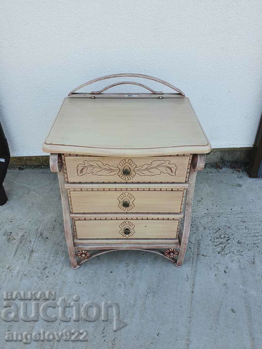 A beautiful wooden chest of drawers with a metal frame!