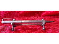 Vintage silver mechanical pencil with markings.