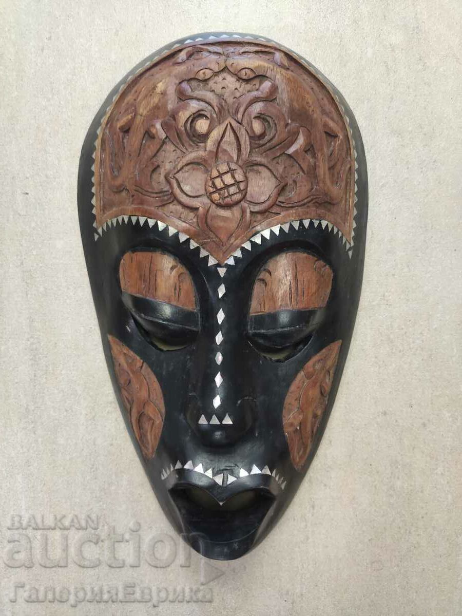 An interesting African mask, two types of wood and mother-of-pearl