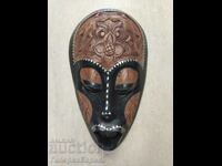 An interesting African mask, two types of wood and mother-of-pearl