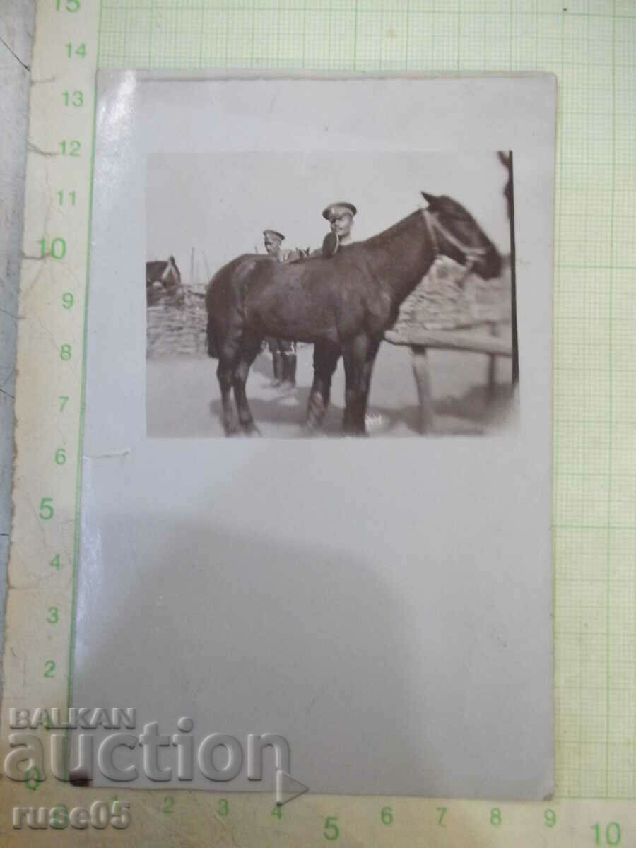 Old photo of two soldiers with a horse