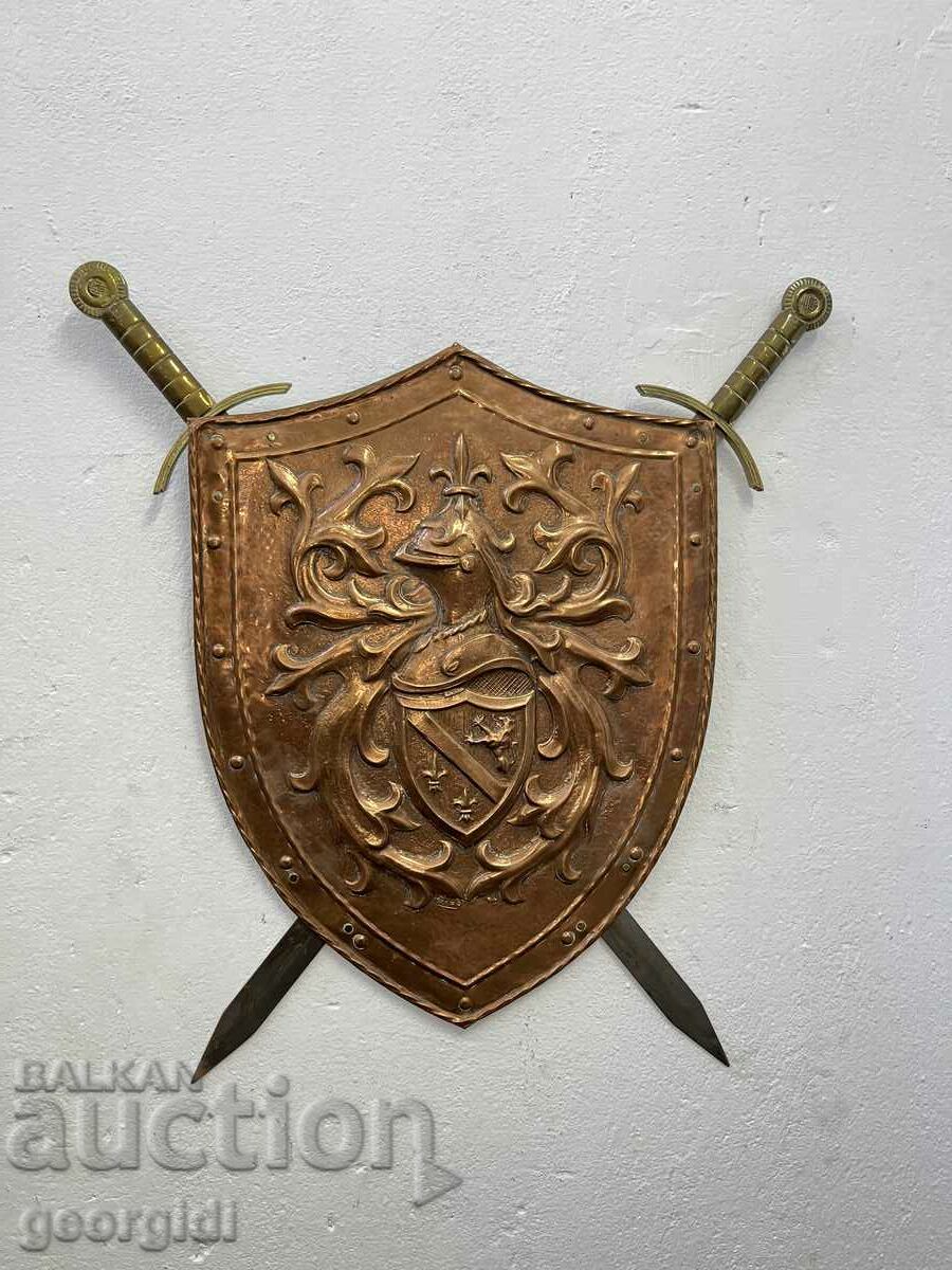 A metal knight's shield with two crossed swords. #5968