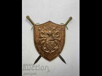 A metal knight's shield with two crossed swords. #5968