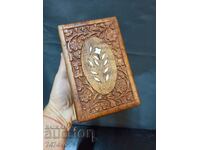 A beautiful wooden jewelry box with rich carving and mother of pearl