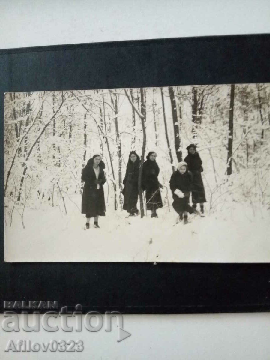 Old photo - ladies in the snowy forest.