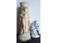 A porcelain figurine and a beautiful vase