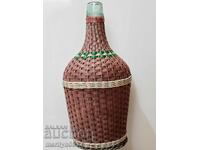 Old damajana with braid, large bottle, glass