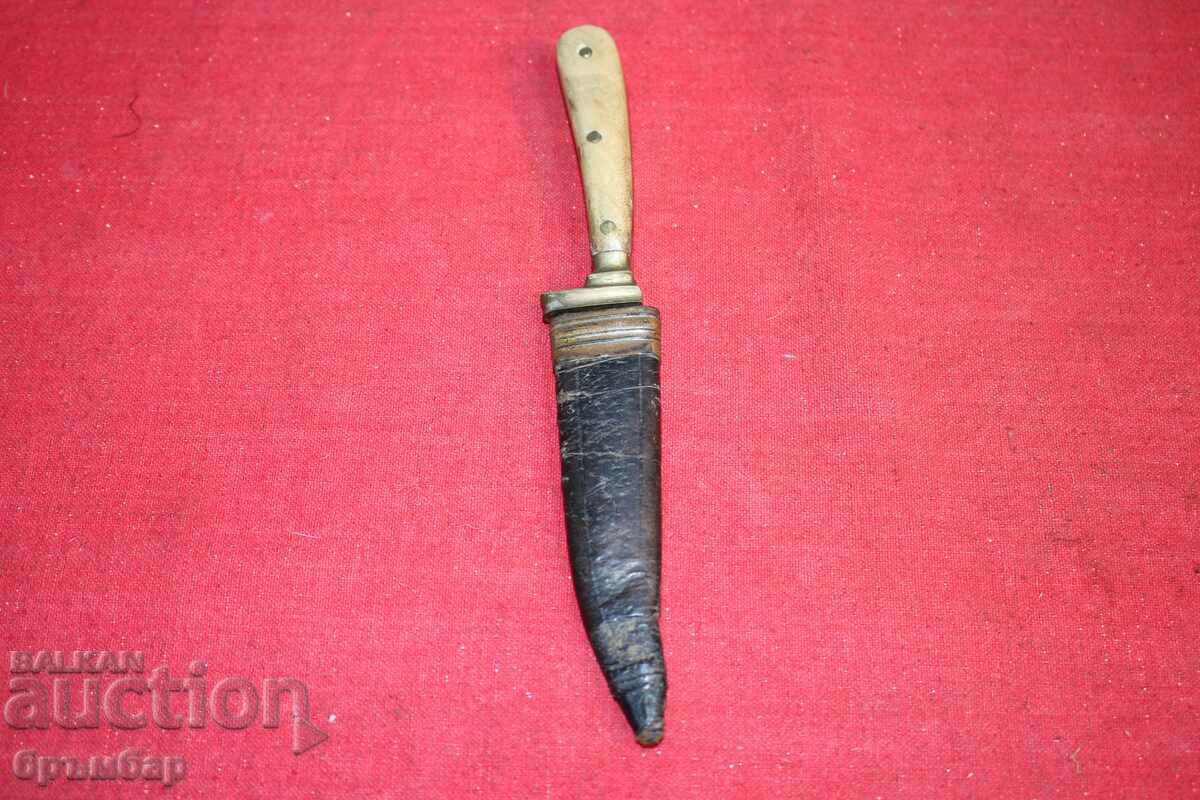 Antique knife with original leather handle.