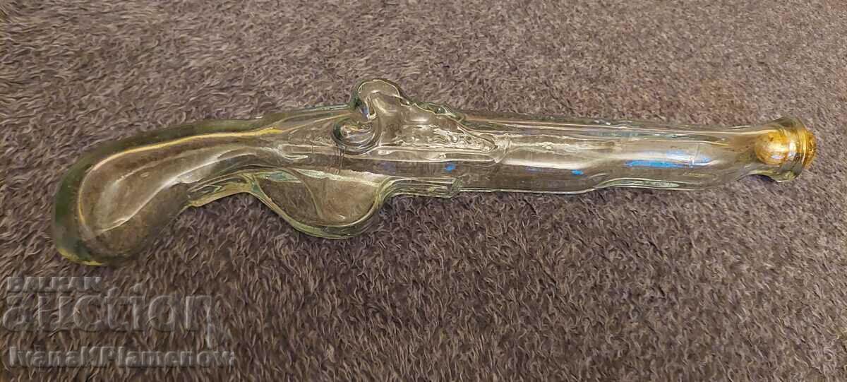 Glass bottle in the shape of a gun