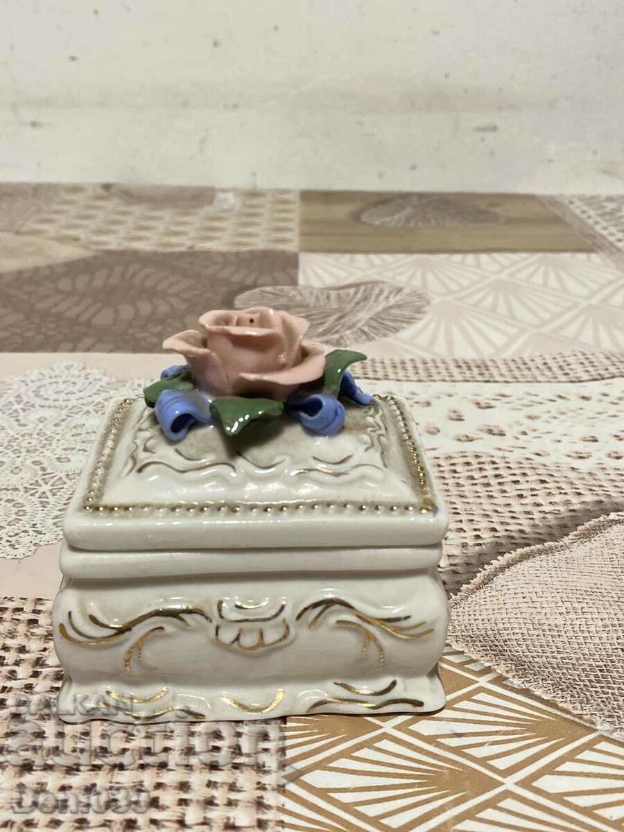 A beautiful porcelain jewelry box with a jewel