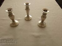 three silver-plated candlesticks for a restaurant large table