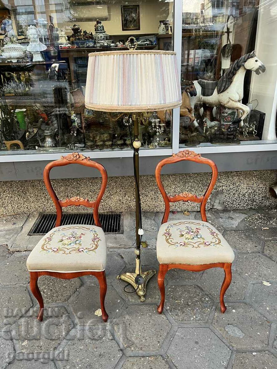 A pair of wooden chairs with embroidery. #6023