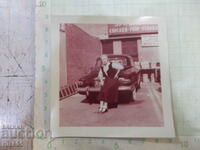 Old photo of a woman in front of the car in America - 1