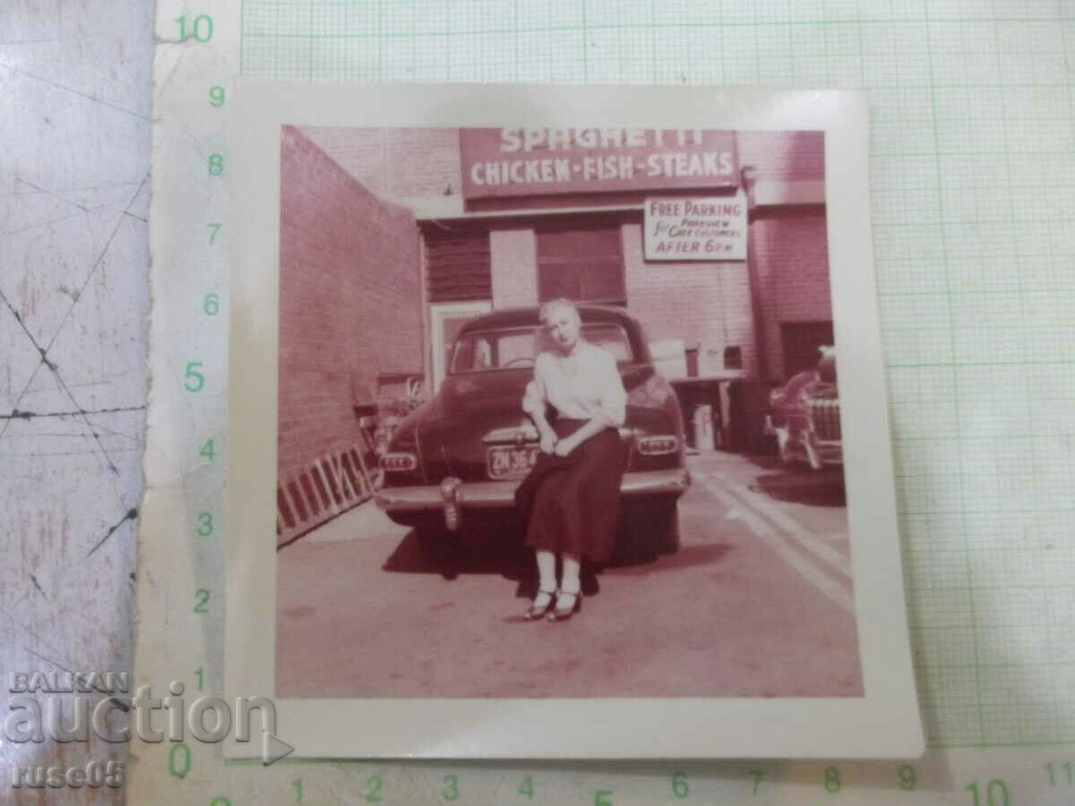 Old photo of a woman in front of the car in America - 2