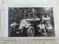 Old photo of a group of young people in a car