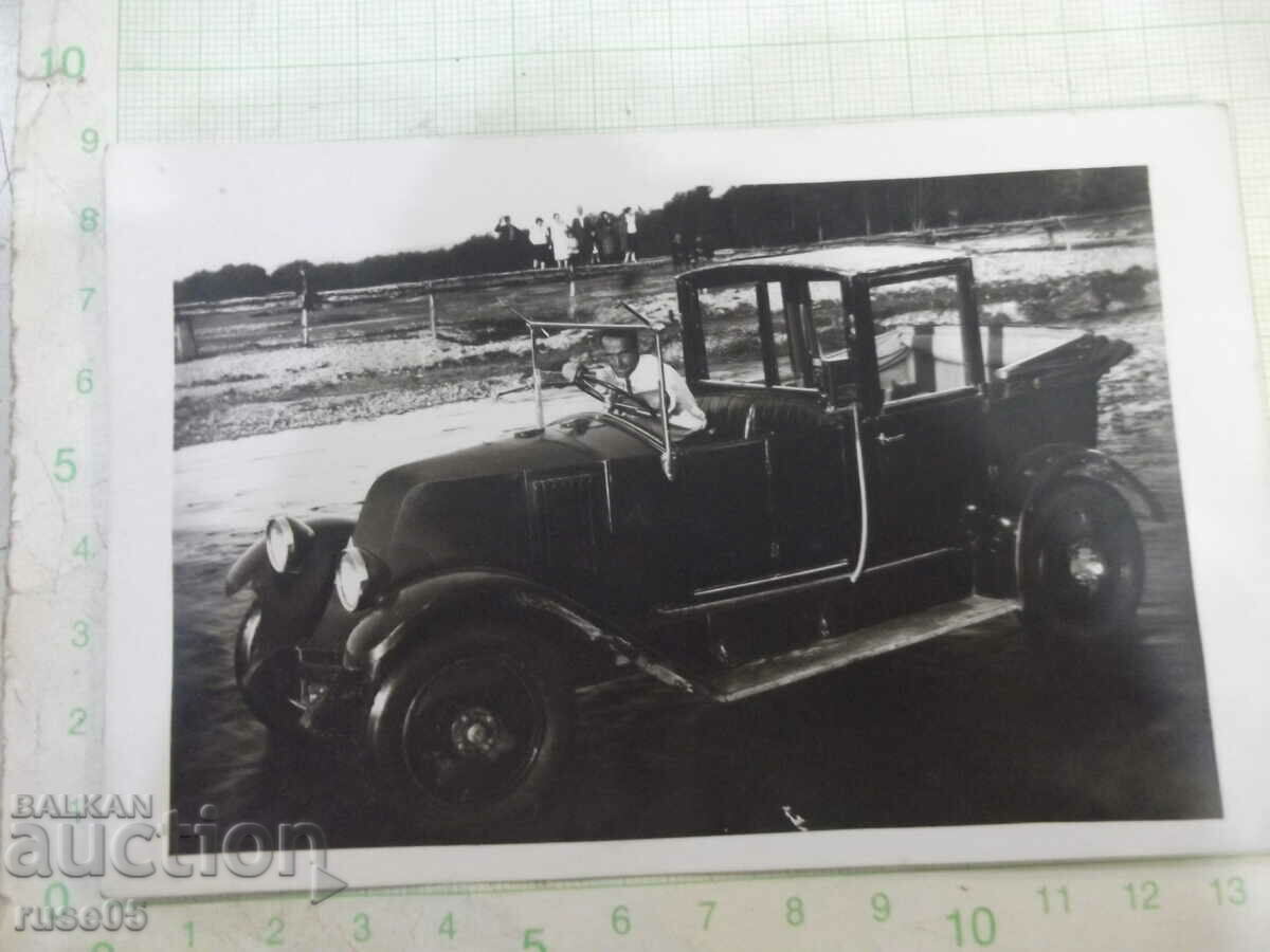 Old photo of a young gentleman in a car