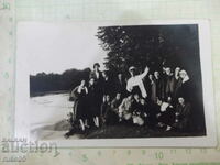 Old photo of young people by the river