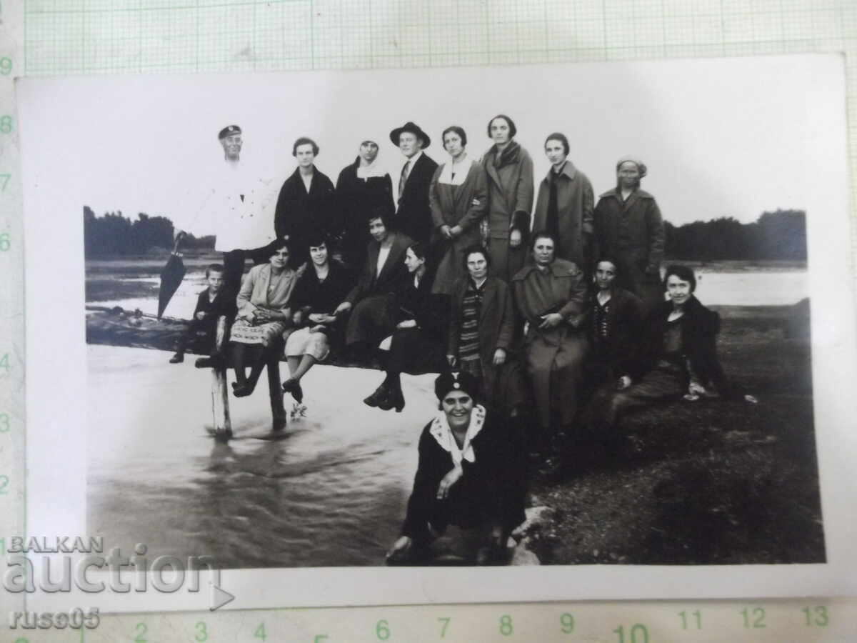 Old photo of young people by the river on a bridge