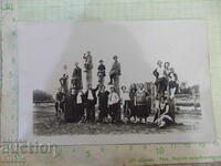 An old photo of a group of young people on two bicycles