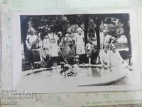 Old photo of a group of young people in front of the fountain