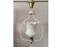 A beautiful white chandelier with a white glass shade