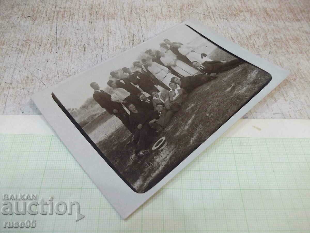 Auction Photo of an old group of young people in the shade on a sunny day Auction Photo of an old group of young people in the shade on a sunny day