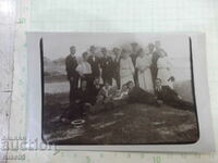 Photo of an old group of young people in the shade on a sunny day