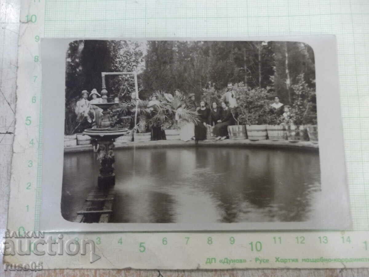 Old photo in the park in front of the fountain