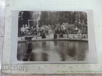 Old photo in the park in front of the fountain