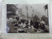 Old photo of a group of young people with a priest for a sermon