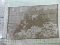 Old photo in front of the fence with a pitcher