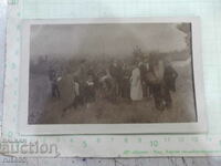 Old photo of a group on the outskirts of town