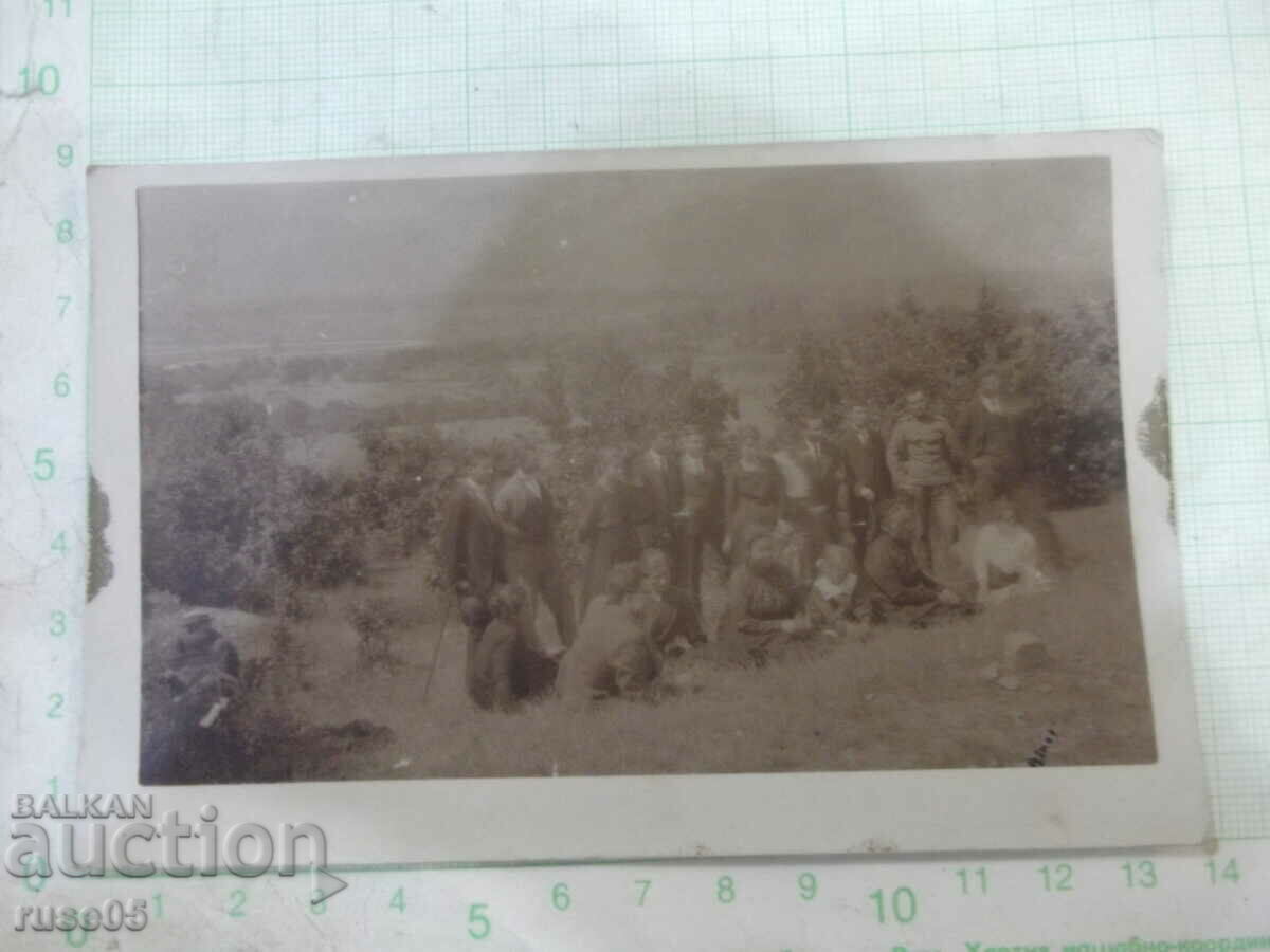 Old photo of a group on the outskirts of town on an outing