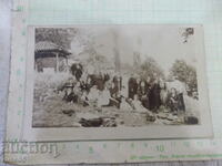 Old photo of a group of young people on an outing with a priest - 1