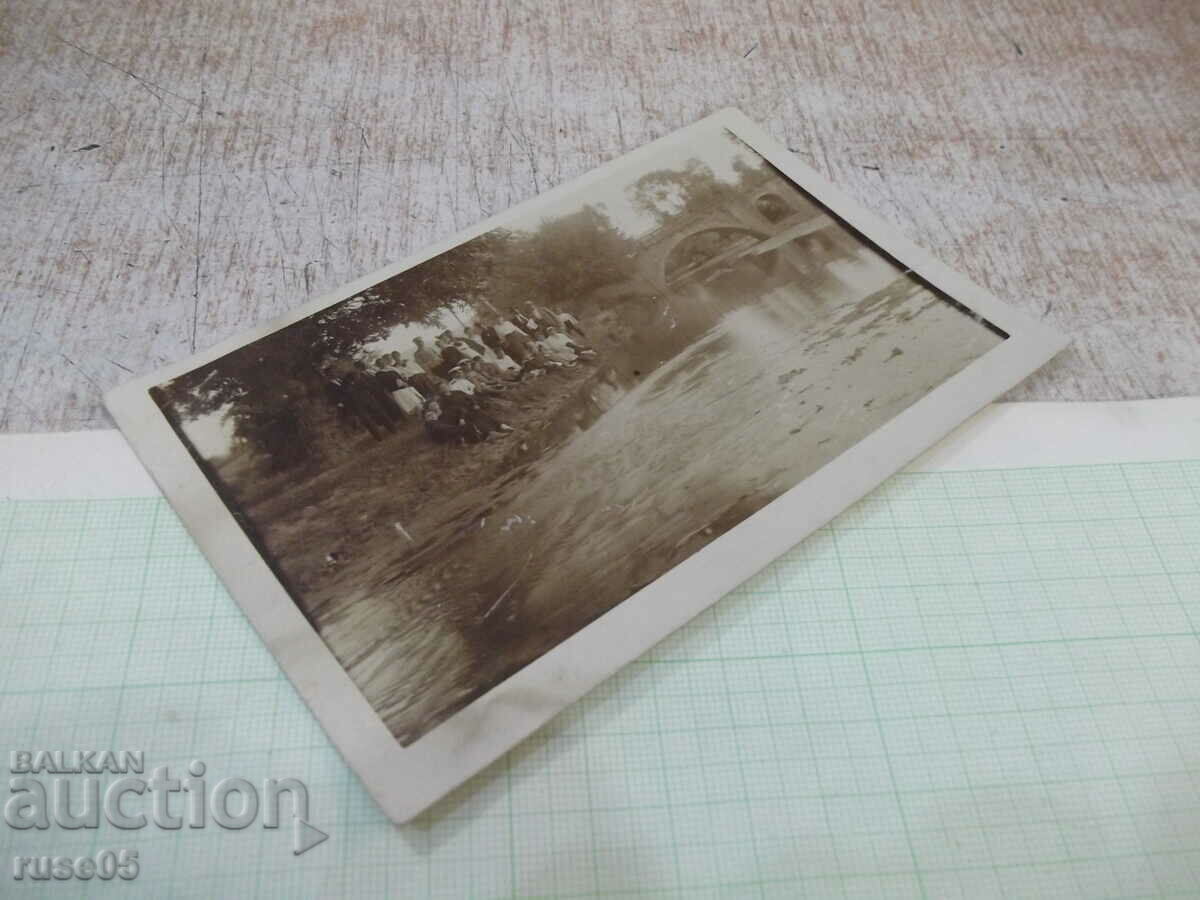 Delivery of An old photo of a group of young people by the river bridge