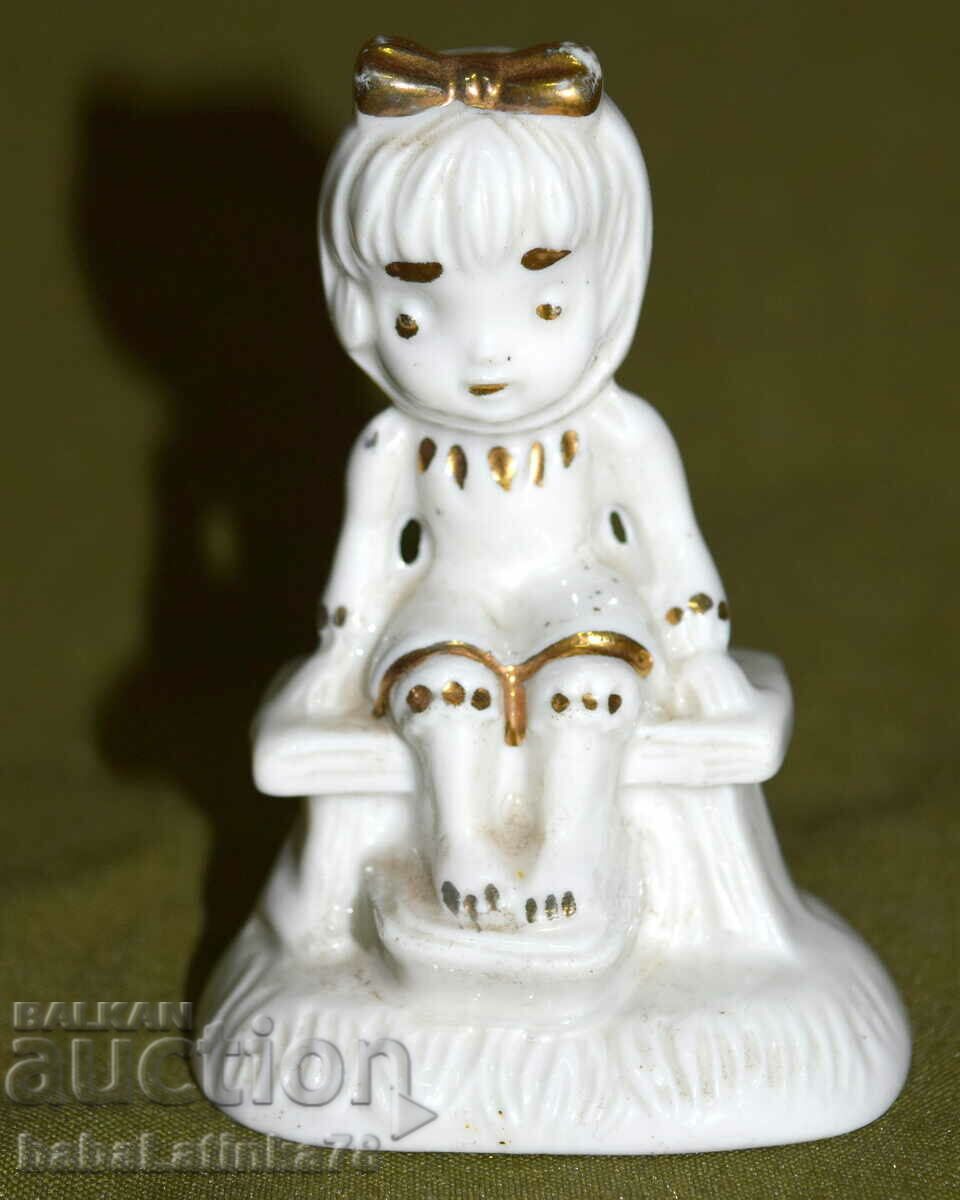 A beautiful little porcelain figurine of a girl