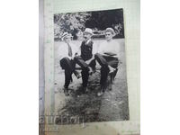 Old photo of three men on a bench